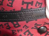 a close up of a handbag with a tag on it