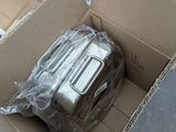 a box of luggage that is sitting in a pile of boxes