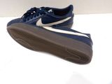 blue and white nike tennis shoes on a white surface