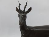 bronze statue of a deer with antelope on its back