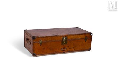 une vieille valise marron posée sur une surface blanche