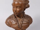 bronze bust of a woman with a collared shirt on a white background