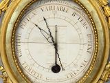 a gold clock with a roman numeral on the face