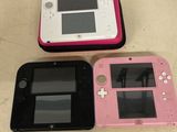 three nintendo wii game consoles sitting on a table