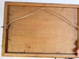 a person holding a wooden box with a string on it