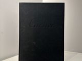 a black book sitting on top of a table next to a white wall