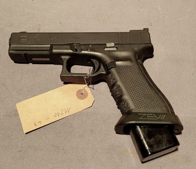 the gun is on the table with a tag attached to it