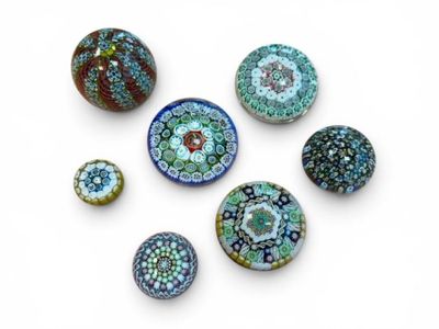 six different types of glass beads on a white surface