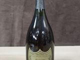 an image of a bottle of champagne sitting on a wooden table