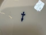a white plate with a cross on it sitting on a table