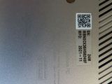 the back of a silver laptop with a qr code on it