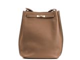 a brown leather handbag with a gold metal handle