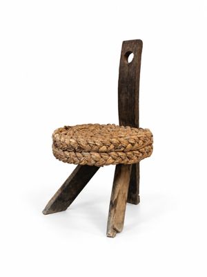 a wooden chair with a woven seat on a white background