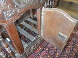 an old wooden cabinet with a door open on the floor