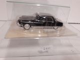 a black car in a clear case on a table