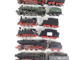 a lot of toy trains sitting on a white surface