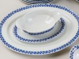 a white table topped with blue and white plates and bowls