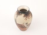 a small vase with a painting on it on a white surface