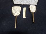two hair brushes and a comb sitting on a table