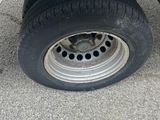 a flat bed trailer with a flat tire on the ground