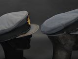 pair of hats on a mannequin head on a black background