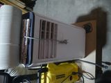 a toaster sitting on top of a table next to a stack of papers
