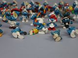 toy figurines of the smurfs are lined up on a table