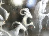 a painting of a group of animals on a black surface
