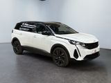 a white suv parked in a room with a black floor