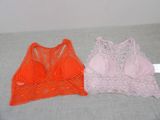 two women ' s bras are sitting on a bed next to each other