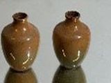 two vases that are sitting on a table