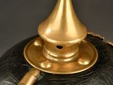 a black and gold vase with a gold handle