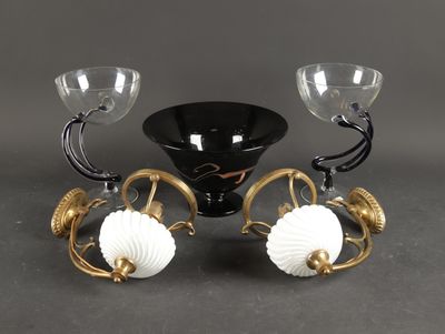 pair of black and gold candlesticks with white glass globes