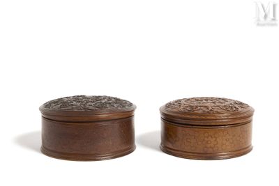 pair of wooden boxes with carvings on top of them on a white surface