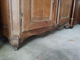 a wooden cabinet that has a door on top of it
