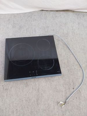a black stove top with two burners on it