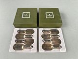 two green boxes with silverware in them sitting next to each other