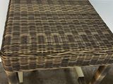 a wicker table with a wooden base and a wicker top