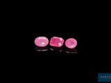 a pair of pink sapphires on a black background