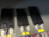 three cell phones that are on display in a store