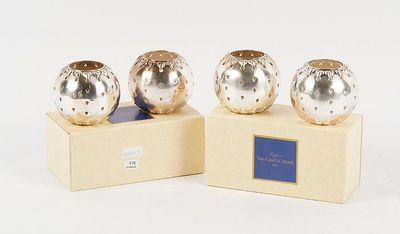 two silver vases sitting on top of a wooden stand