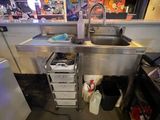 a kitchen with a sink and a refrigerator in it