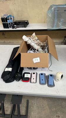 a box of cell phones on a table with other items