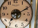 a clock that is on display in a glass case