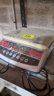 a cake sitting on top of a scale on a table