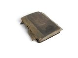 an old book that is sitting on a white surface