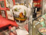 une vitrine sur laquelle est posé un vase, dans une pièce