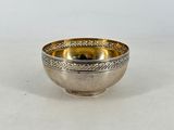 a small silver bowl with a rope design on the rim
