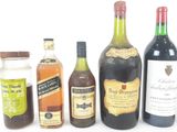 several bottles of alcohol are lined up on a white surface