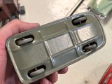 a person holding a tray with four compartments in it